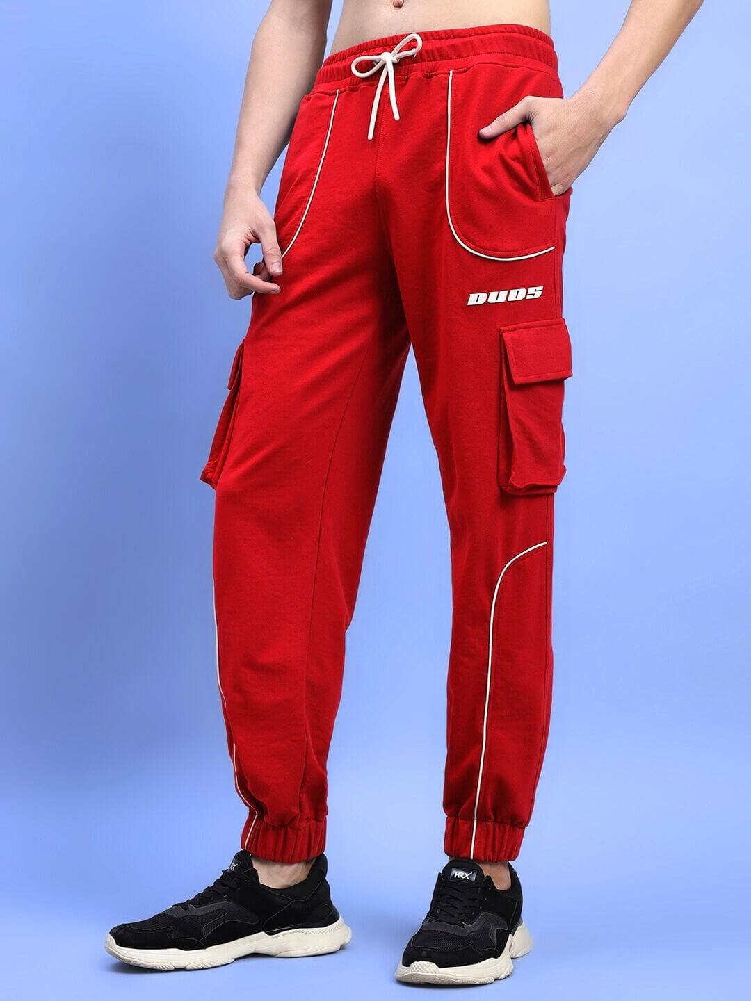 Red DEVENO Relaxed-Fit Joggers with pockets and drawstring waist, showcased on a light blue background, trendy and customizable fit.