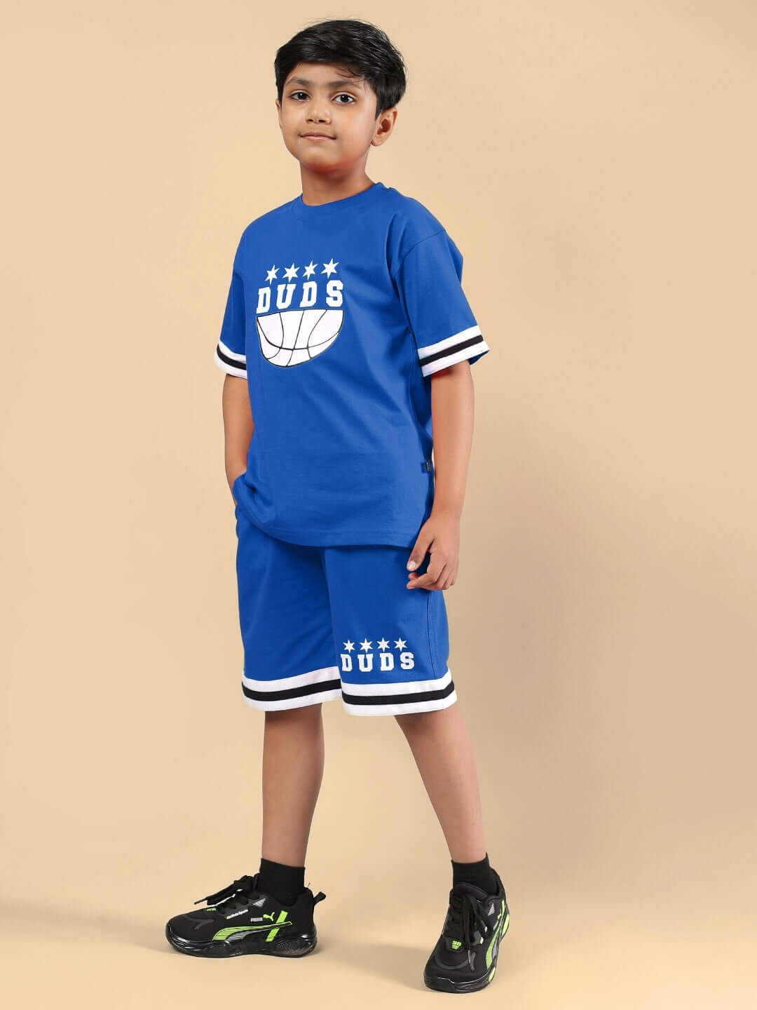 Child wearing stylish DIGGIN CO-ORD FOR BOYS & GIRLS BLUE outfit made to order, showcasing DUDS branding for a trendy look.