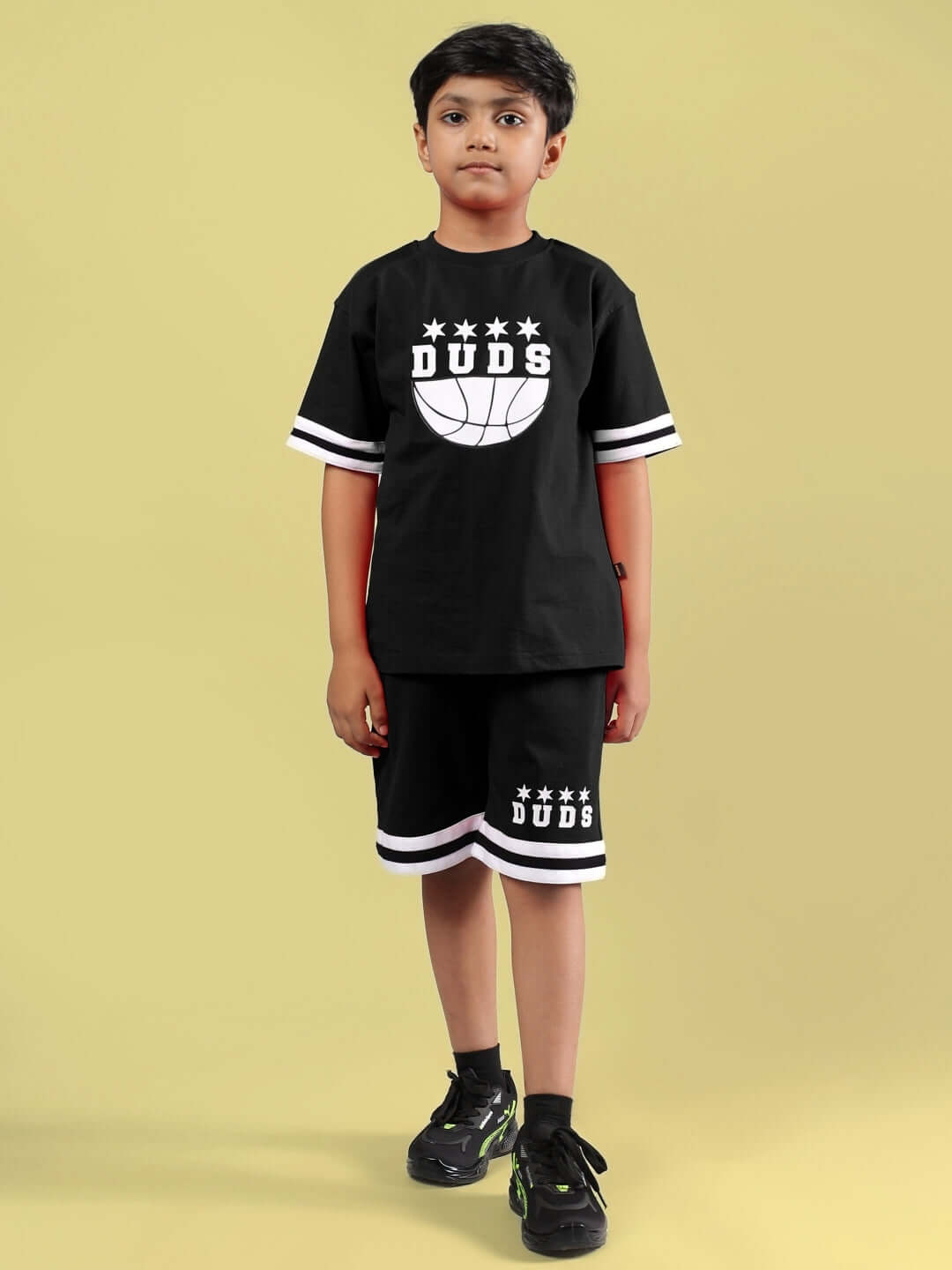 Young boy wearing DIGGIN CO-ORD FOR BOYS & GIRLS BLACK by DUDS, featuring a sporty black t-shirt and shorts set.