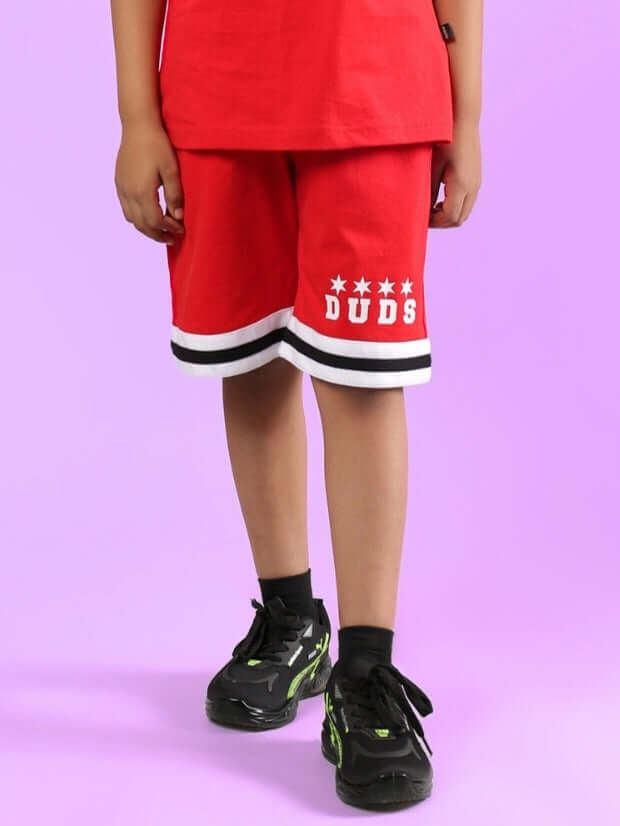 DIGGIN SHORTS FOR BOYS & GIRLS RED displayed on a child, featuring black and white trim, perfect for casual wear by DUDS.