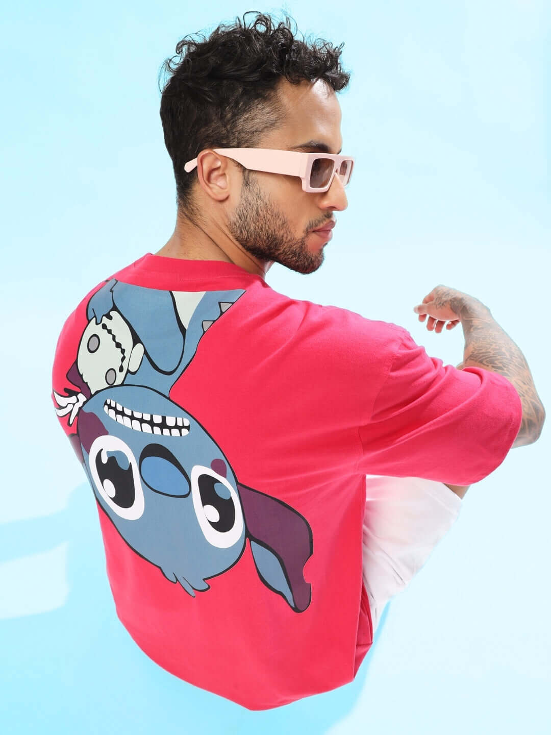 Man wearing a pink Disney Lilo oversized t-shirt with character design, featuring handmade custom fit option.