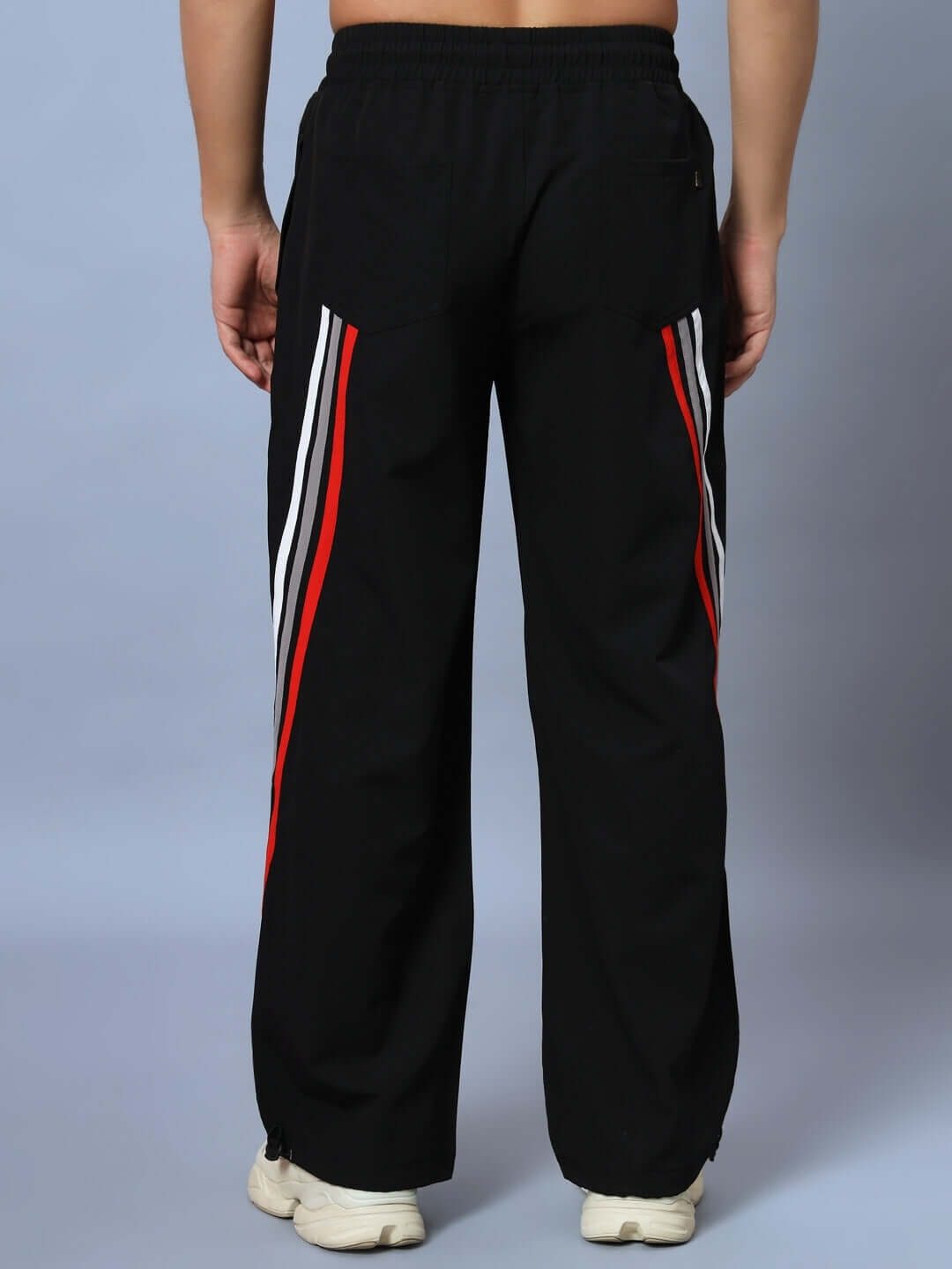 Back view of DOBBIN relaxed fit jogger in black with red and white side stripes.
