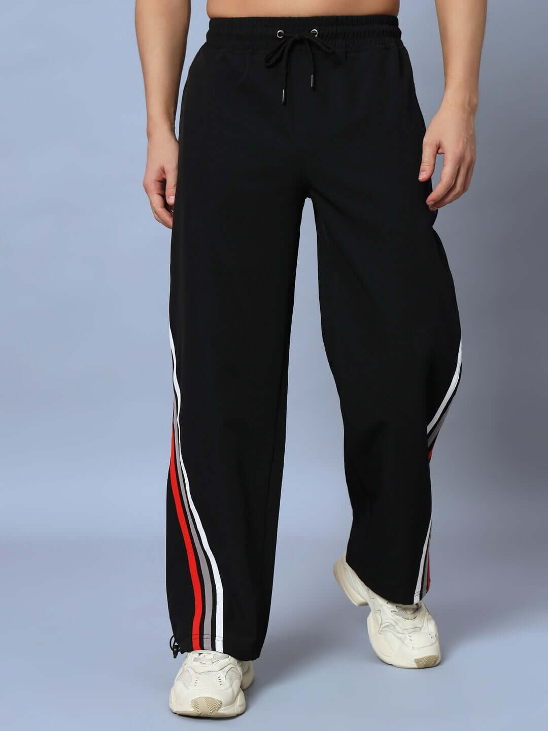 Man wearing DOBBIN relaxed fit black jogger pants with side stripes, customizable sizing available from DUDS.