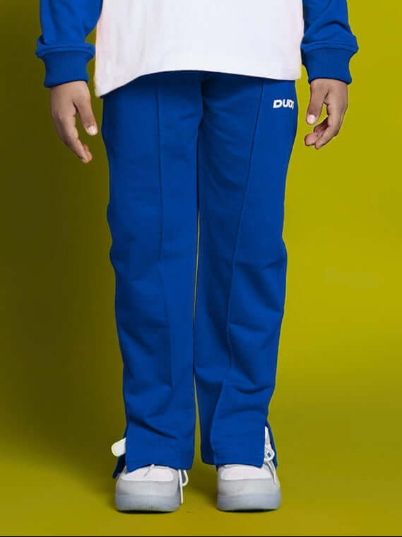 Child wearing blue Doraemon jogger pants for boys and girls, perfect for comfortable everyday wear.