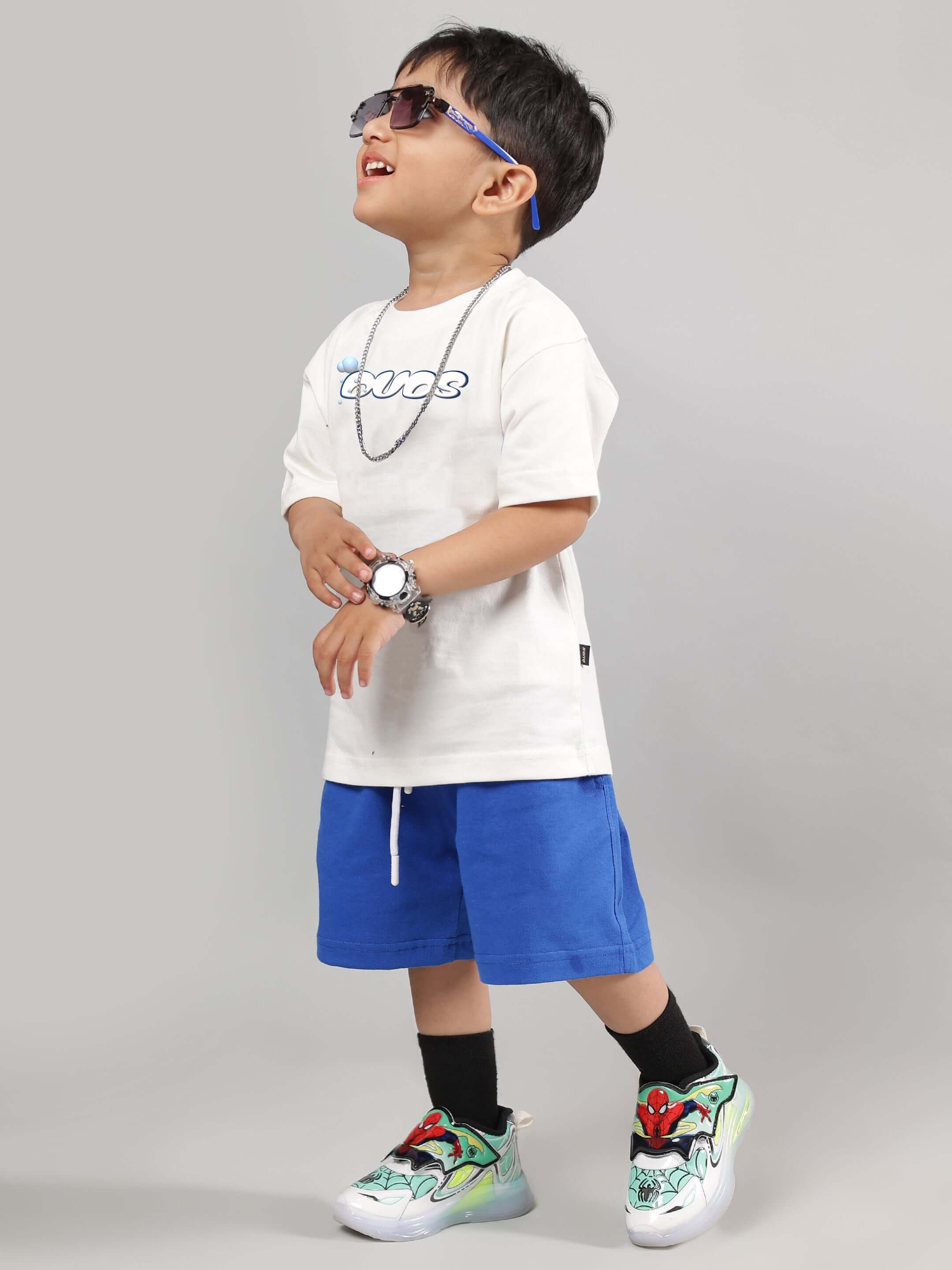 Child wearing Doraemon Summer Co-Ord for Boys Girls Off White-R Blue, featuring a white tee and blue shorts, stylish and breathable.