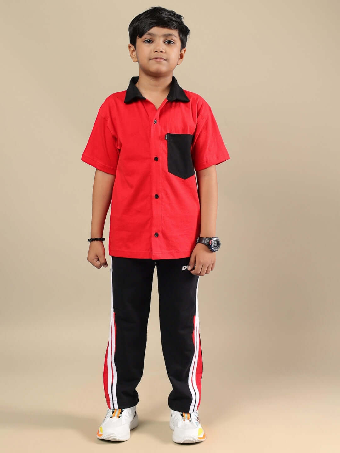 Child wearing DORIC CO-ORD FOR BOYS & GIRLS RED-BLACK featuring sporty red shirt and black pants, perfect for casual and active outings.
