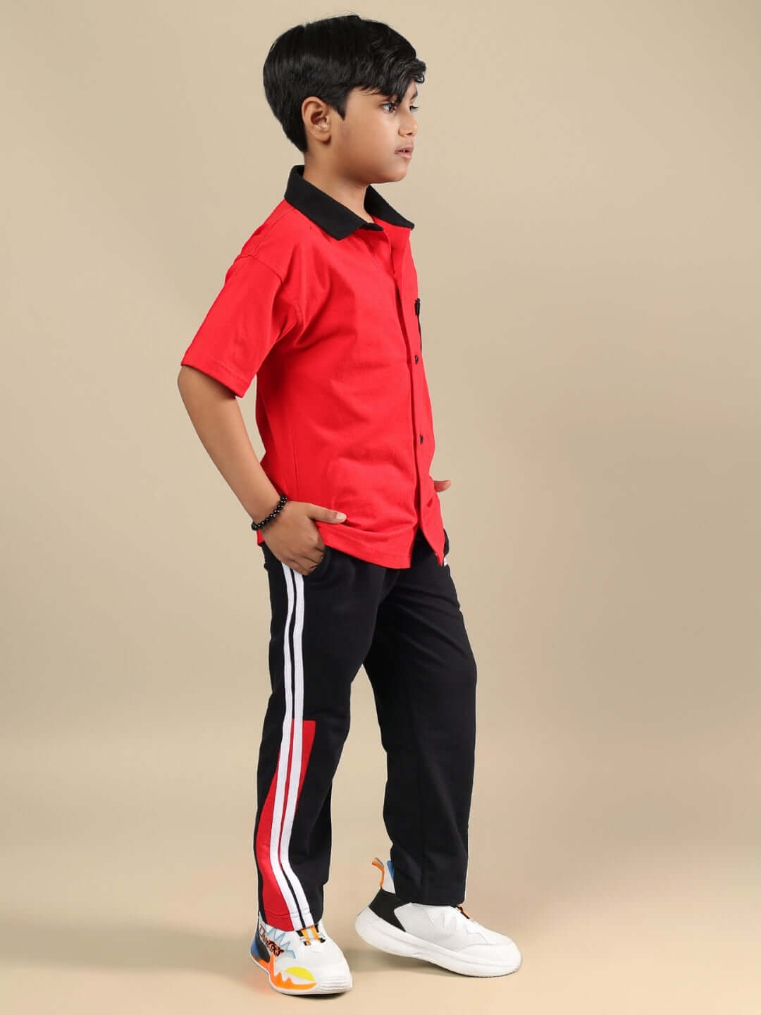 Child wearing DORIC CO-ORD FOR BOYS & GIRLS RED-BLACK outfit, showcasing sporty style and comfort for active kids.
