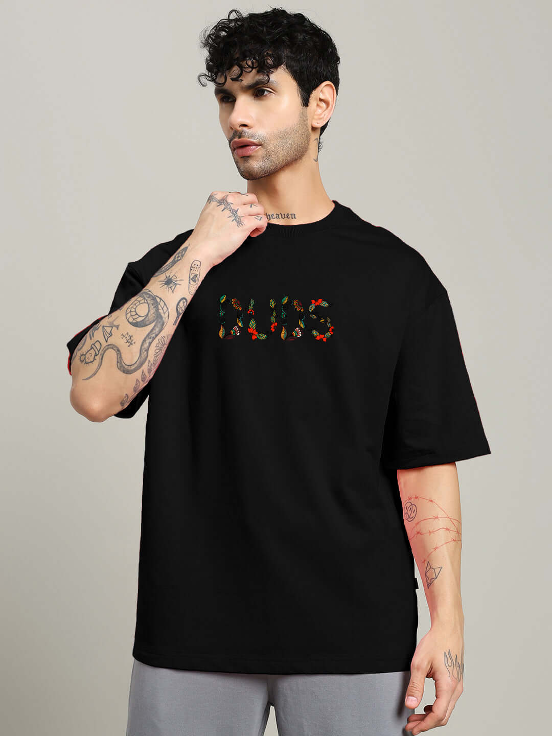 Model wearing Dragonfly Oversized Black T-Shirt made from premium cotton French terry with colorful print, manufactured in India.