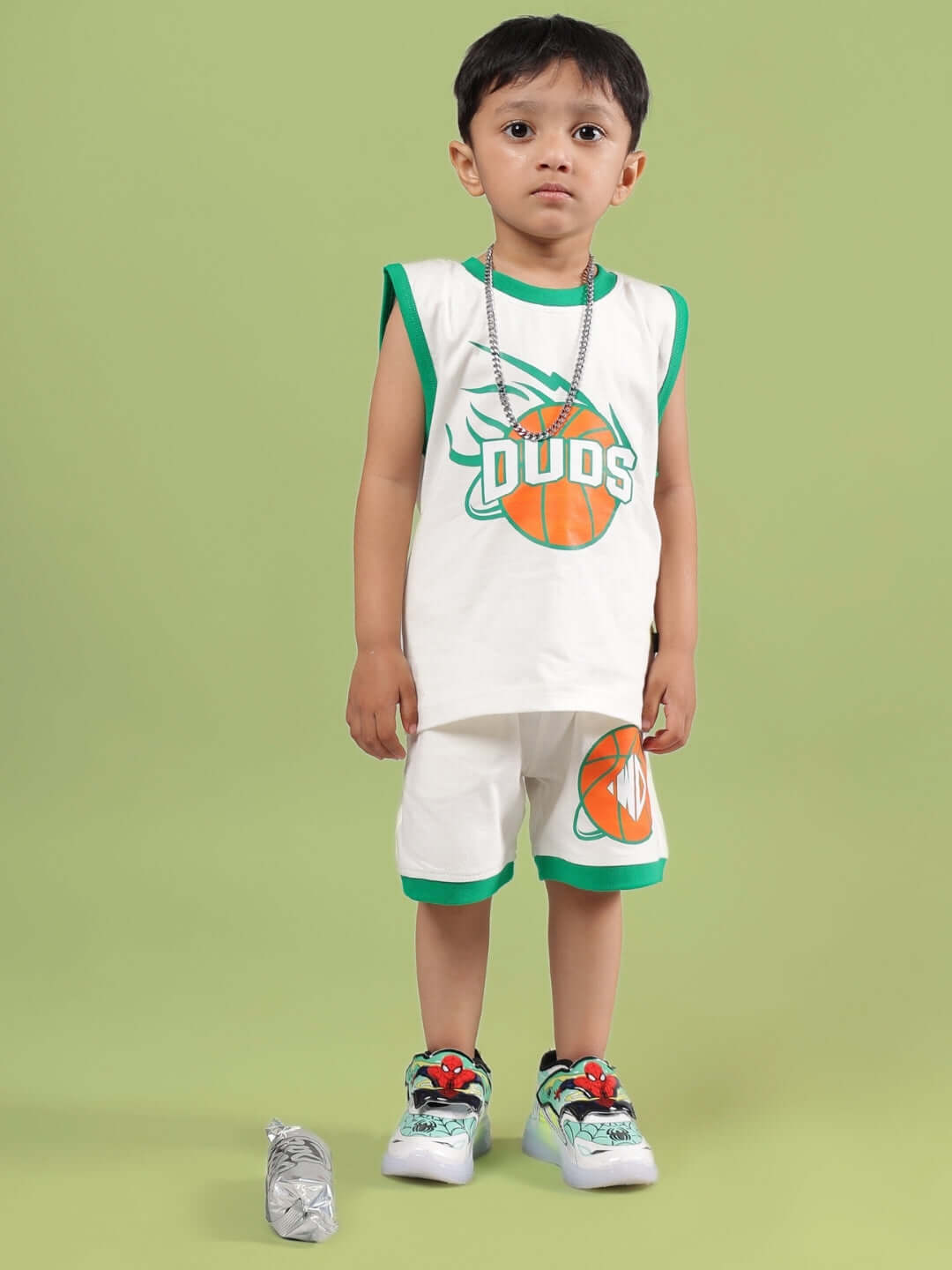 Child wearing off-white Dribble co-ord set with basketball design, suitable for boys and girls. Made to order by DUDS.