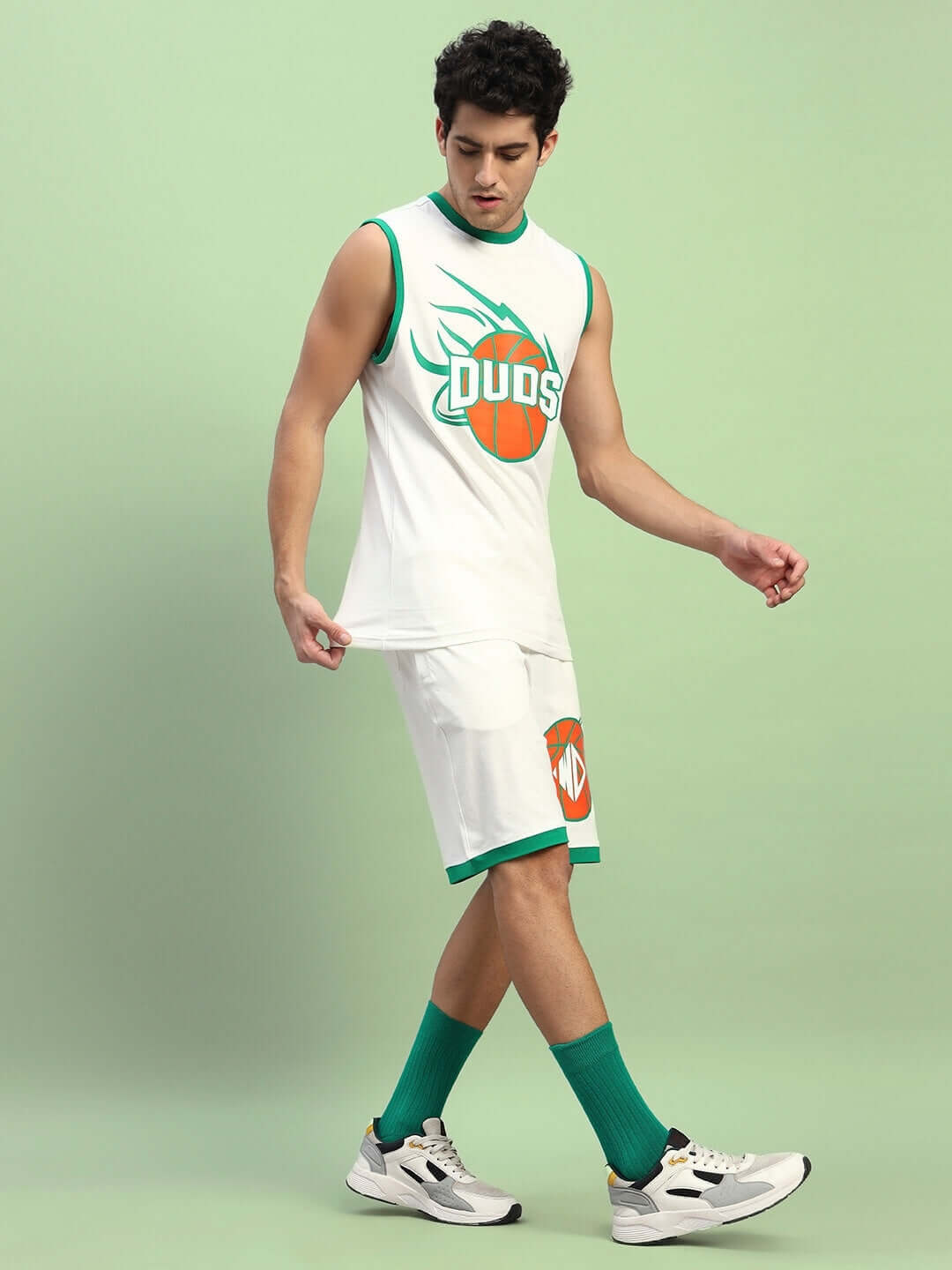 Model wearing DRIBBLE CO-ORD SET SLEEVELESS OFF WHITE, featuring sleeveless top and shorts in off-white with a sporty design.