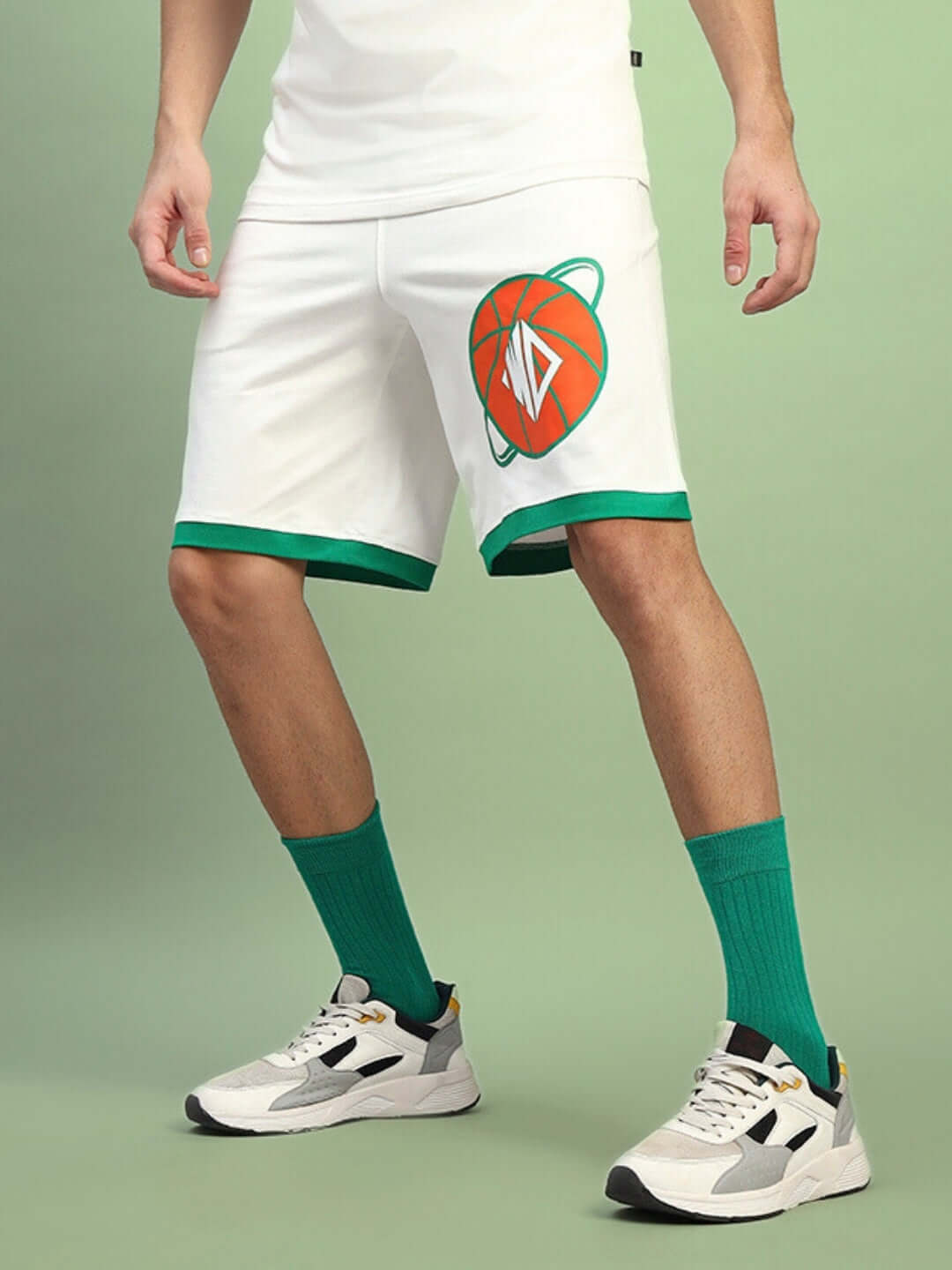 Model wearing DRIBBLE SUMMER SHORTS OFF-WHITE with green trim and basketball graphic, perfect for casual summer activities.