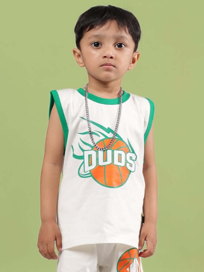 Young boy wearing DRIBBLE T-SHIRT FOR BOYS & GIRLS OFF WHITE with green trim and basketball graphic.