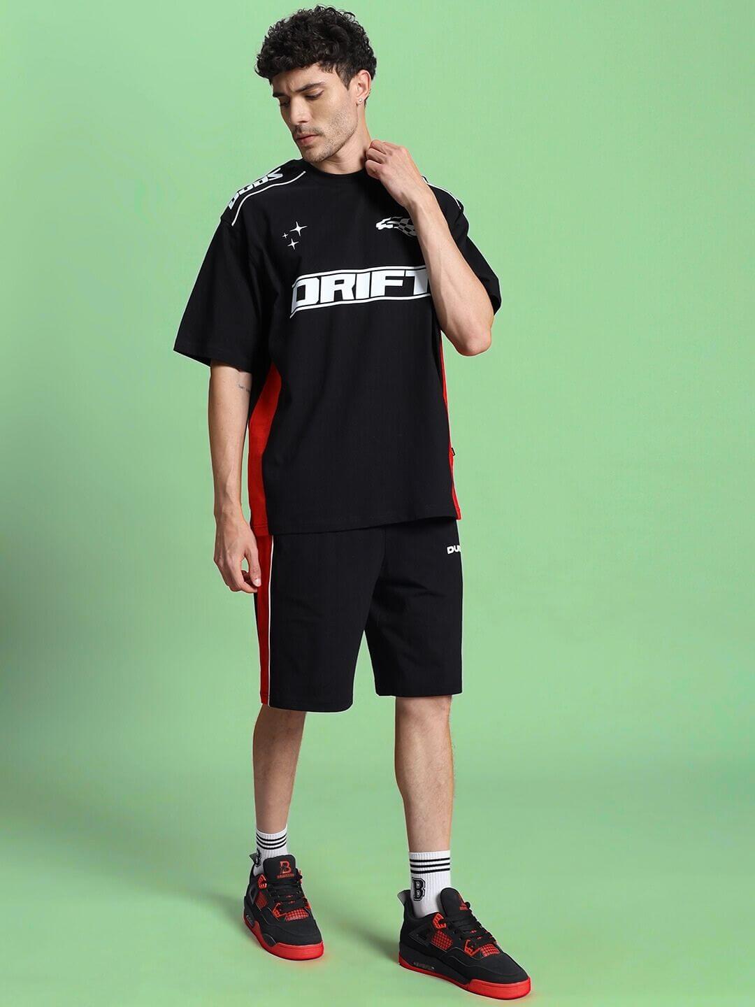 Person wearing DRIFT SUMMER COTTON TERRY CO-ORD SET BLACK against a green background