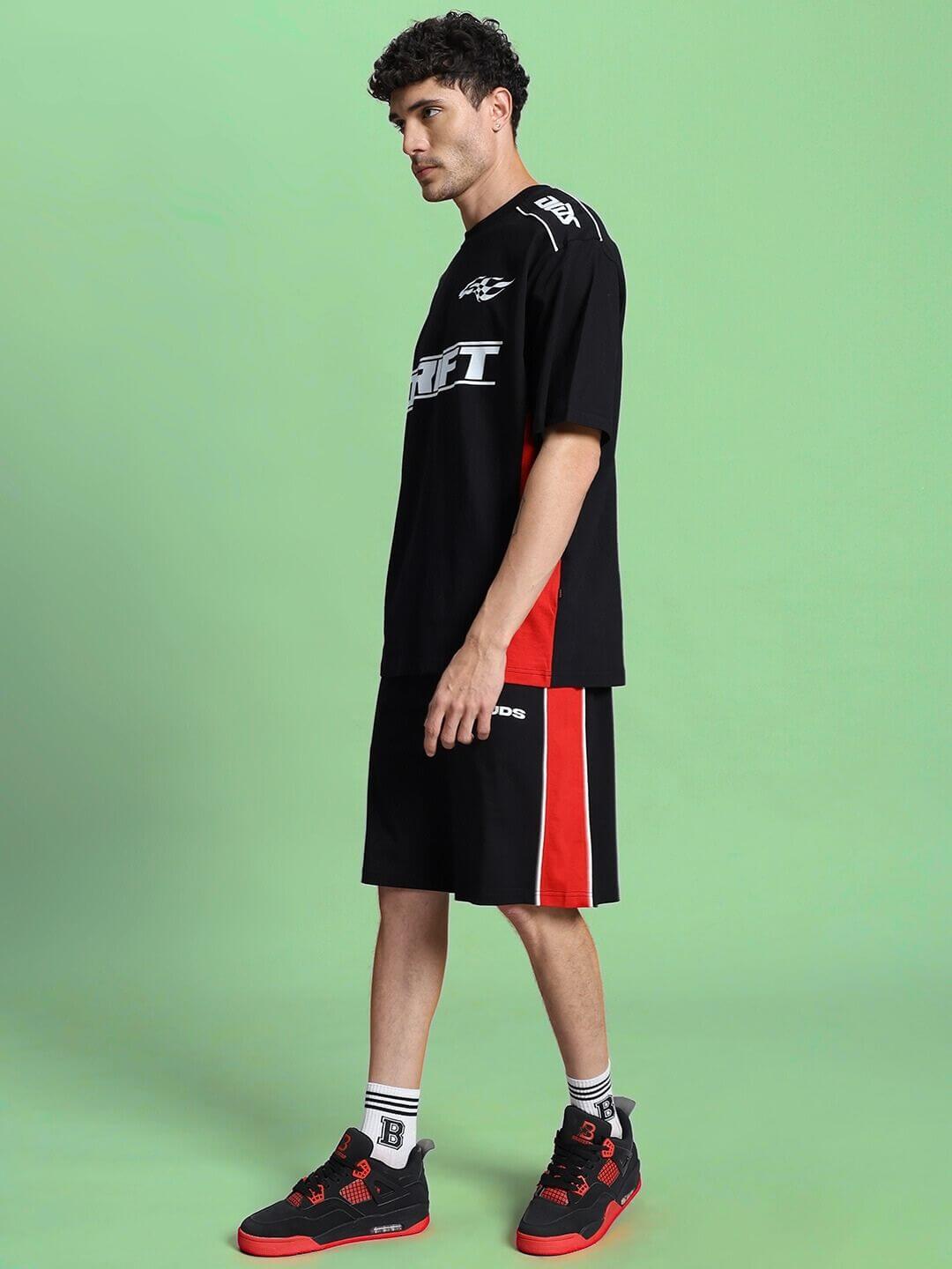 Model wearing DRIFT SUMMER COTTON TERRY CO-ORD SET BLACK against green background.