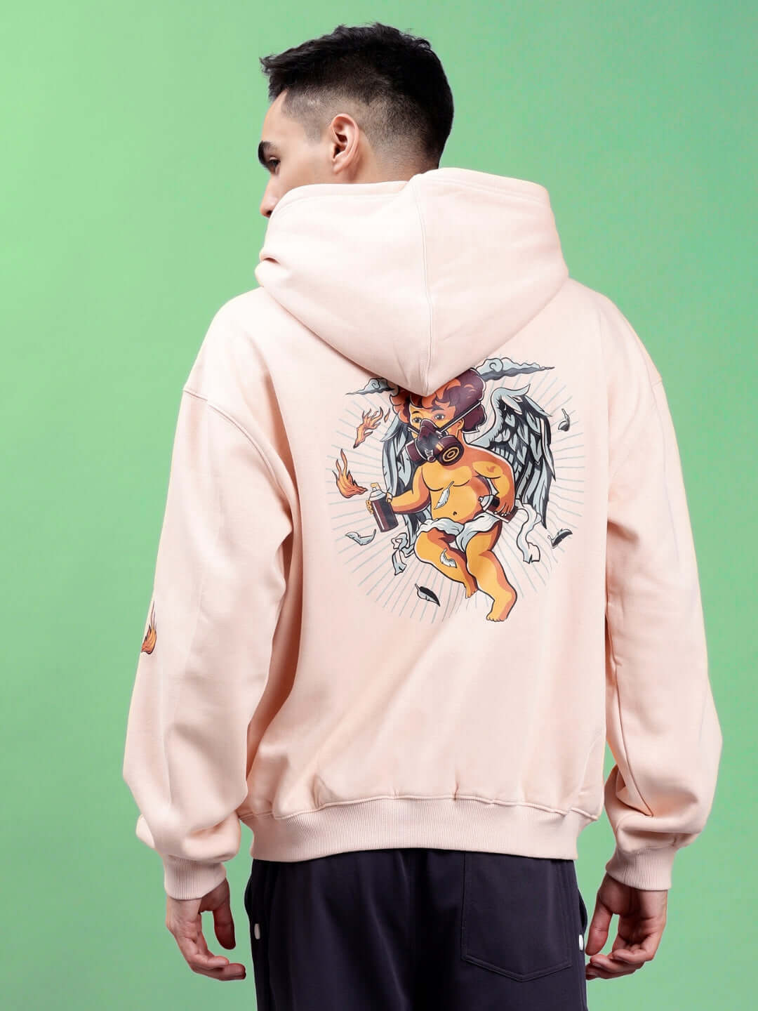 Model wearing DRIP CUPID OVERSIZED HOODIES BEIGE featuring a bold graphic design on the back, perfect for stylish streetwear.
