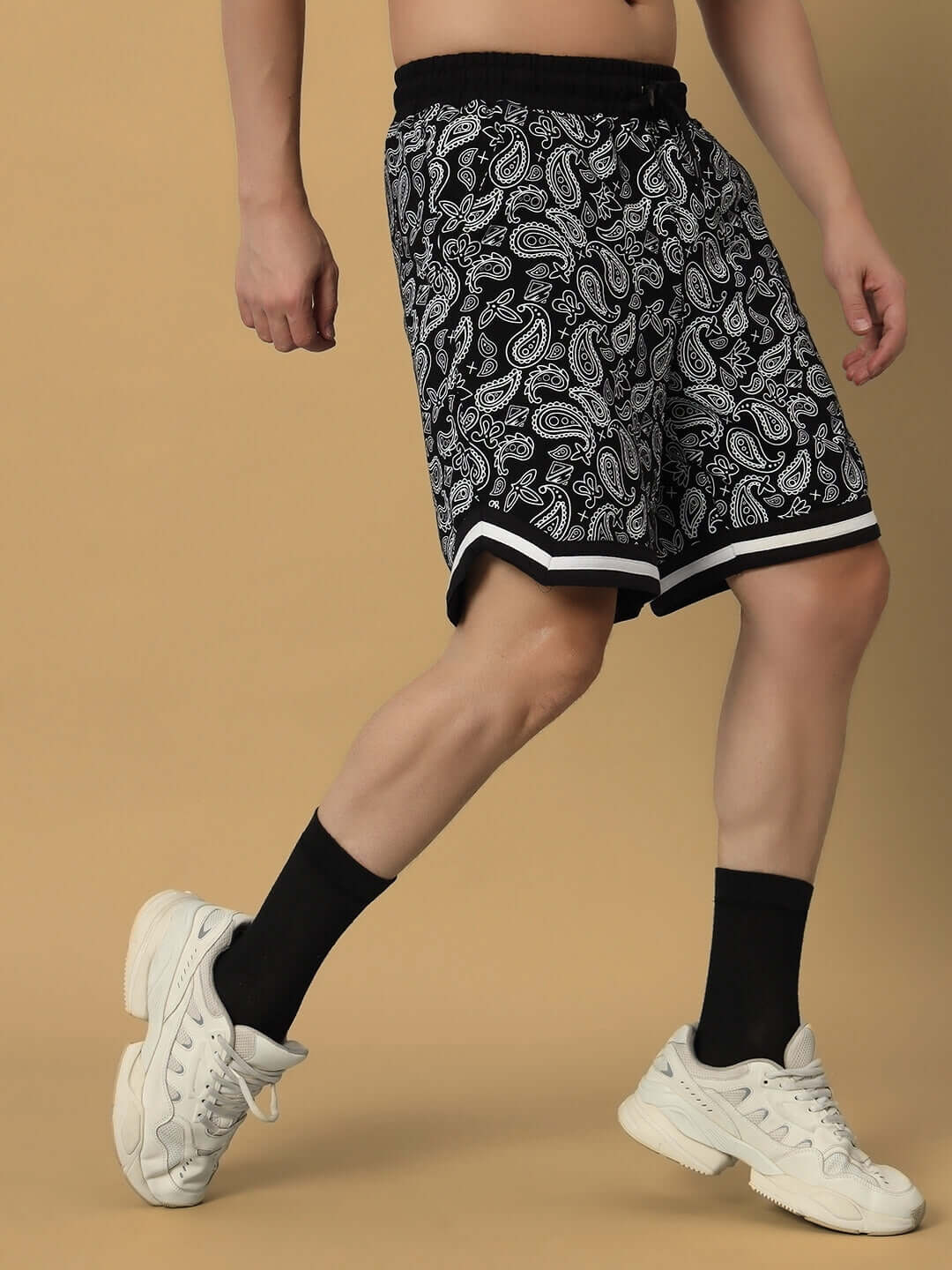 Model wearing Drizzle Regular Fit Black Shorts with paisley pattern, demonstrating stylish casual fashion. Available in custom fit.