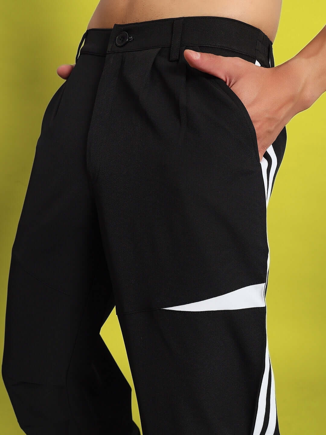 Side view of Drove Relaxed Fit Cargo Pants in black with custom fit option against a vibrant background.