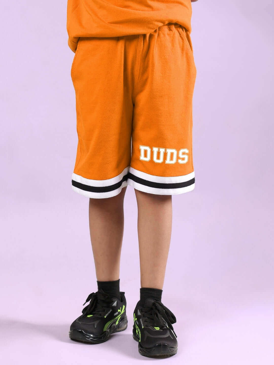 DUDS CHICAGO SHORTS FOR BOYS & GIRLS ORANGE worn by a child, showcasing the vibrant design and comfortable fit.