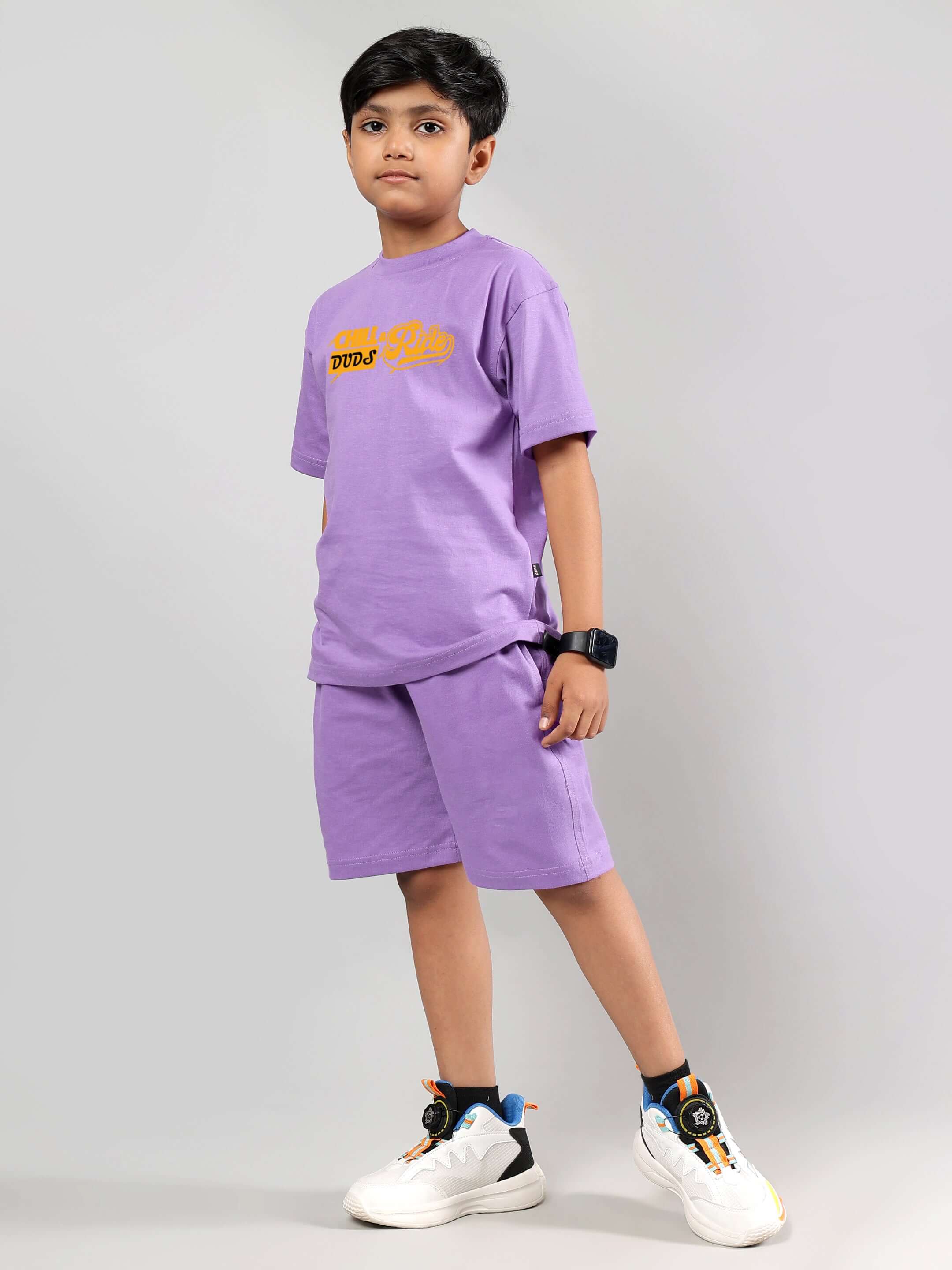 Boy wearing DUDS lavender co-ord set, featuring a casual t-shirt and shorts, ideal for boys and girls. Stylish and comfortable fit.