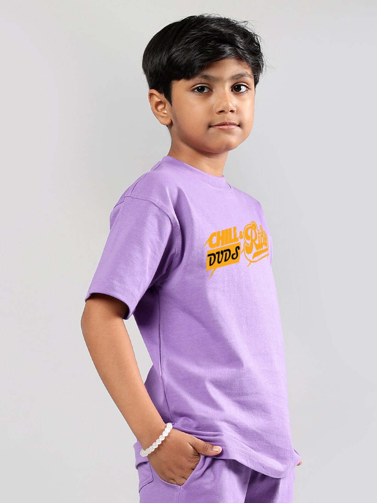 Child wearing DUDS lavender Chill & Ride T-shirt for boys & girls, side view