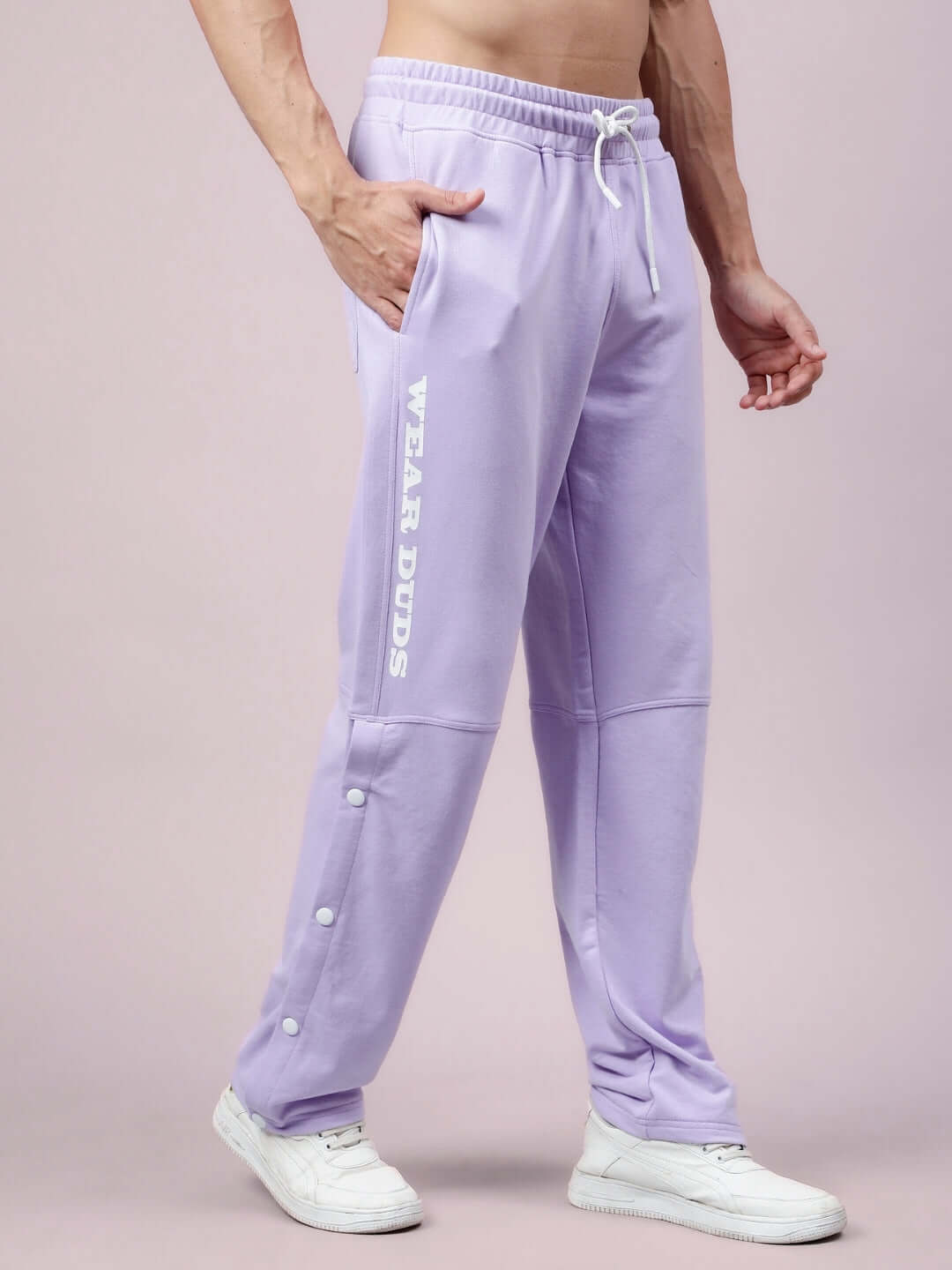 Alt Tag: Lavender DUDS Racer Joggers with side text, shown worn by a model, featuring a comfortable fit and custom button details.