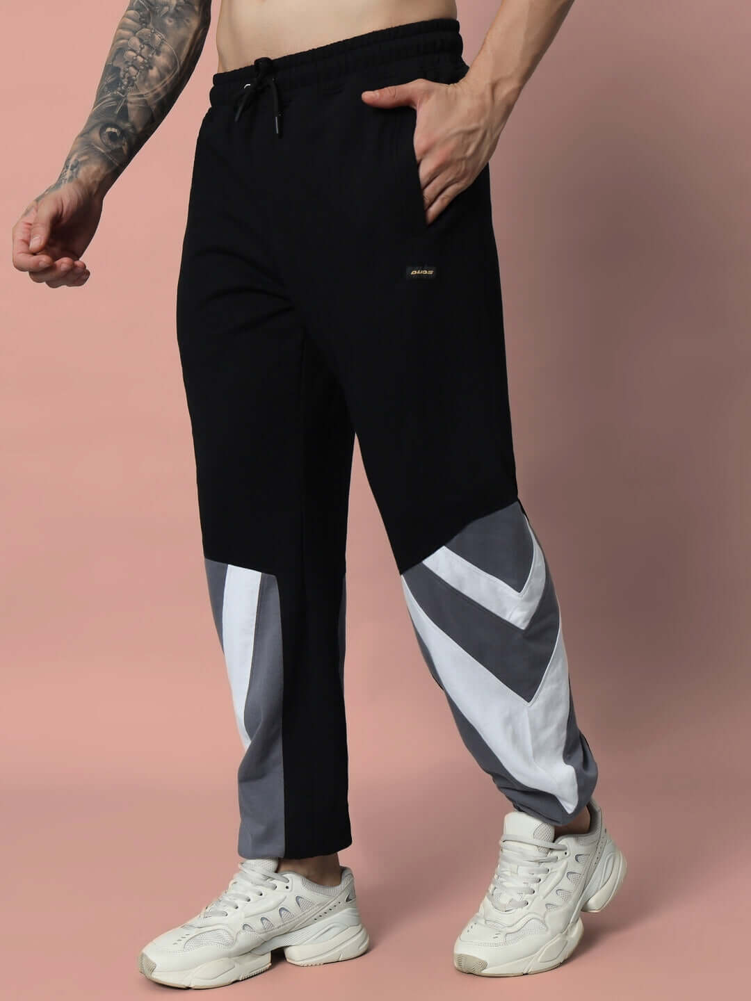 Black DUDS relaxed fit joggers with gray and white accents, made-to-order by experienced tailors, featuring a customizable fit option.