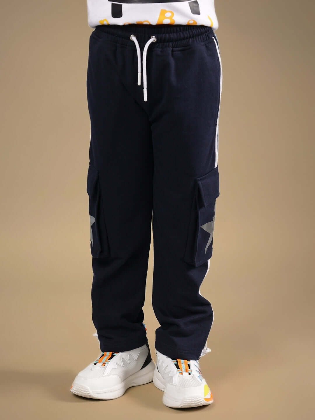 Navy blue DUDS FORCE joggers for boys and girls, featuring cargo pockets and a drawstring waistband, displayed on a child model.