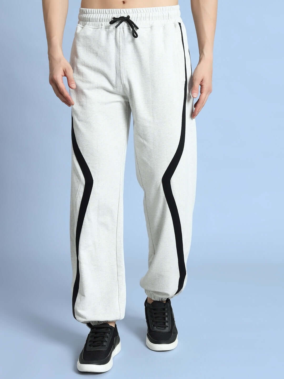 Model wearing DUDS FRAME Joggers in melange grey with black stripes, showcasing comfortable fit and design for casual wear.