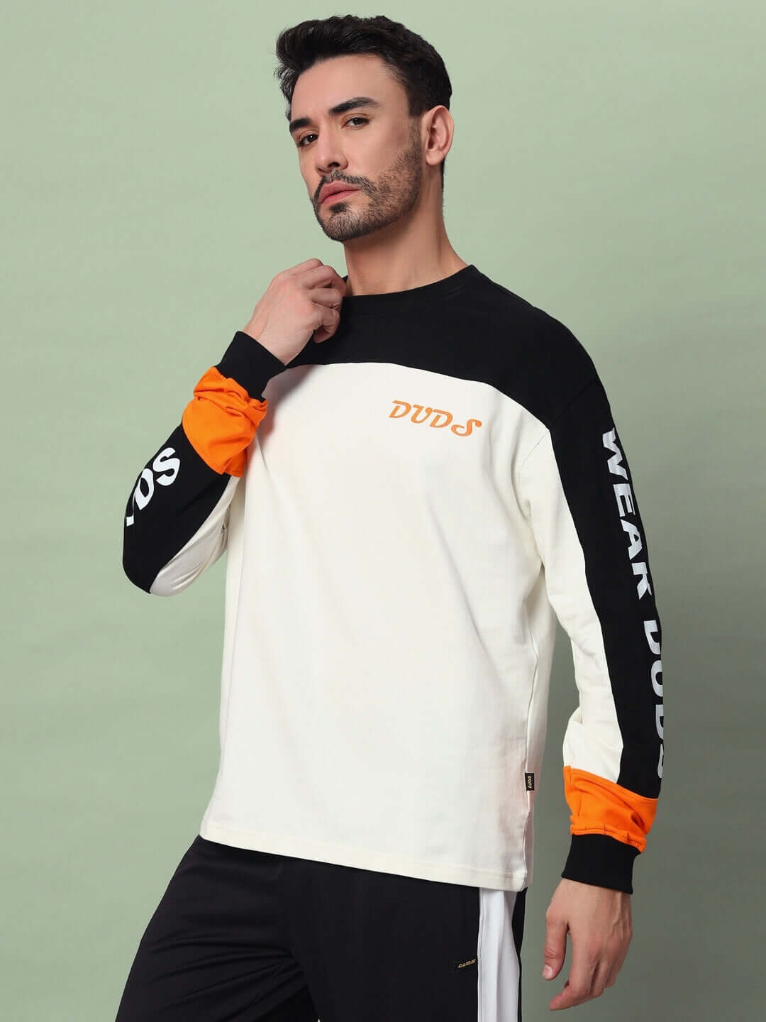 DUDS Geometric Oversized Sweatshirt in Black-Off White, showcasing premium cotton French terry fabric with stylish orange accents.
