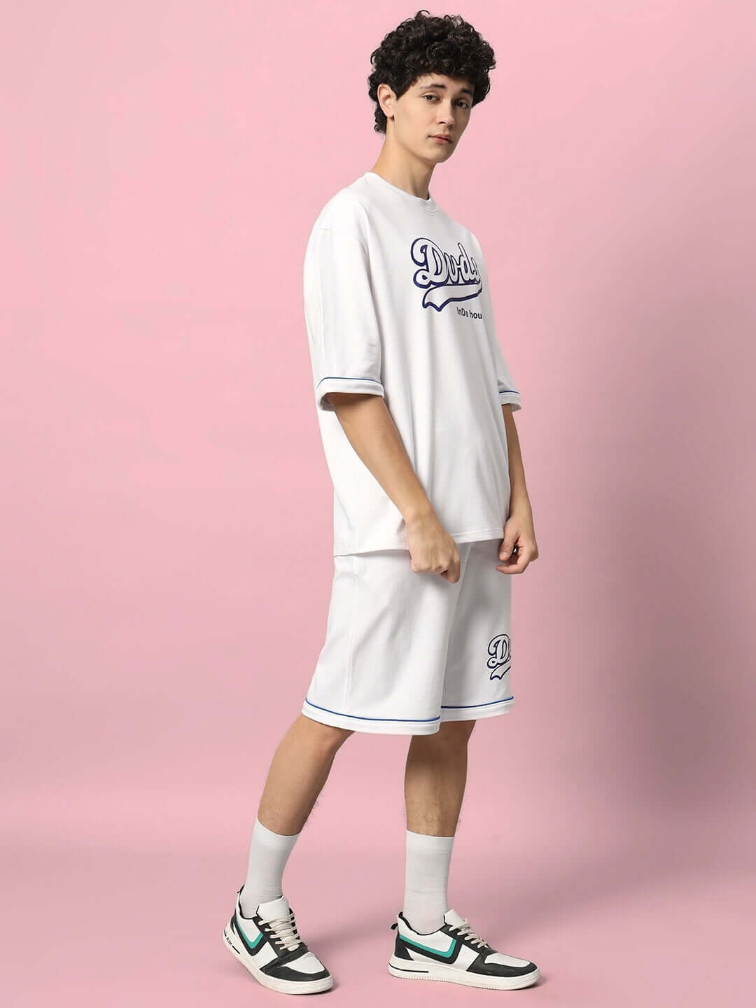 Model wearing DUDS INDA HOUSE COLORBLOCK CO-ORD SET in white, crafted from 97% cotton French terry Lycra, on a pink background.