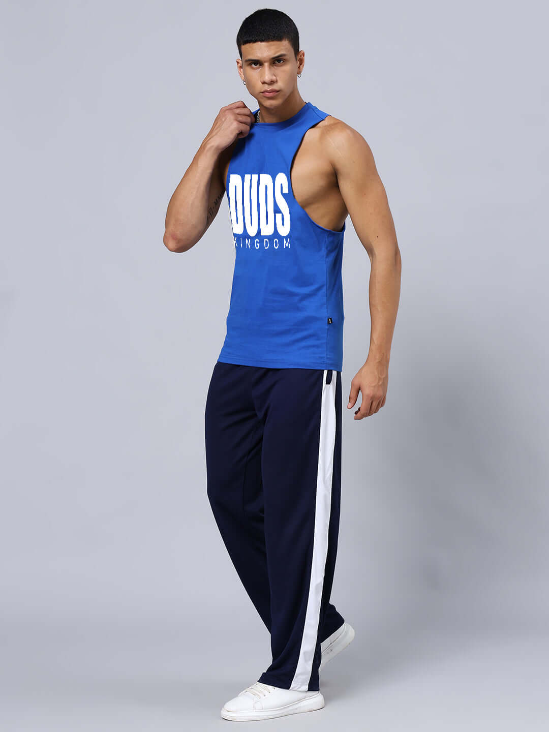 Model wearing DUDS KINGDOM GYM CO-ORD SET BLUE with relaxed fit joggers and blue tank top, unisex style.