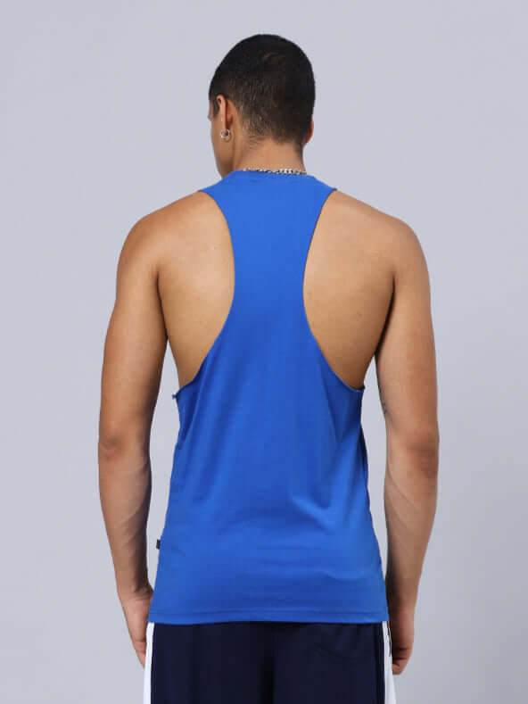 Back view of athlete wearing DUDS KINGDOM GYM SLEEVELESS T-SHIRT BLUE, showcasing breathable fabric and racerback design in gym setting.