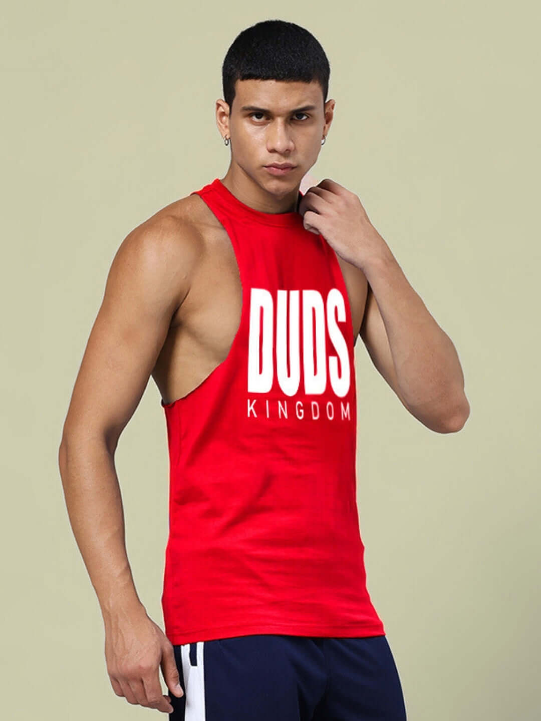 Man wearing red DUDS KINGDOM gym t-shirt, showcasing athletic fit and casual style.