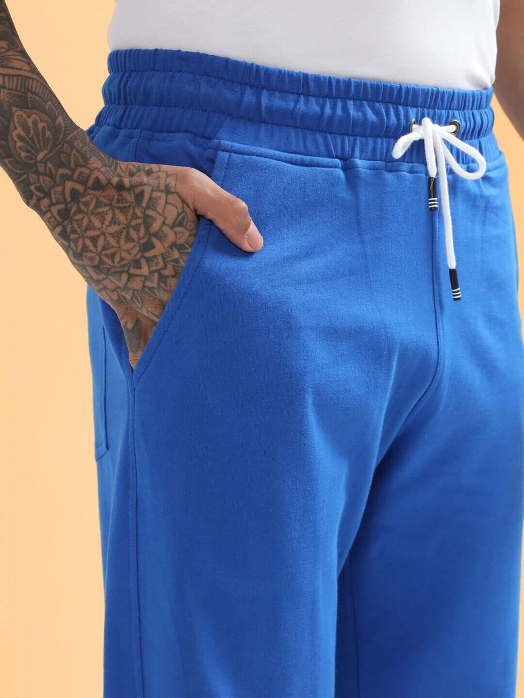 Royal blue limited edition jogger by DUDS featuring a white drawstring, crafted by experienced tailors for a custom fit option.