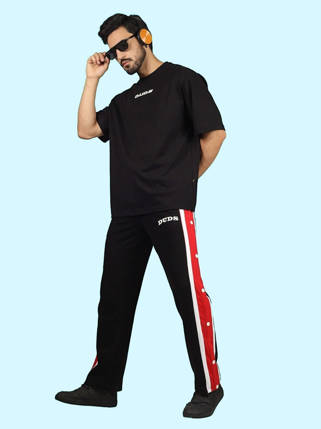 Man wearing DUDS Magician Joggers in black with red stripe, featuring custom fit option, made to order by experienced tailors.