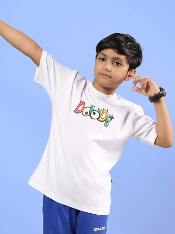 Boy wearing DUDS MONSTER T-SHIRT FOR BOYS & GIRLS WHITE, striking a playful pose.