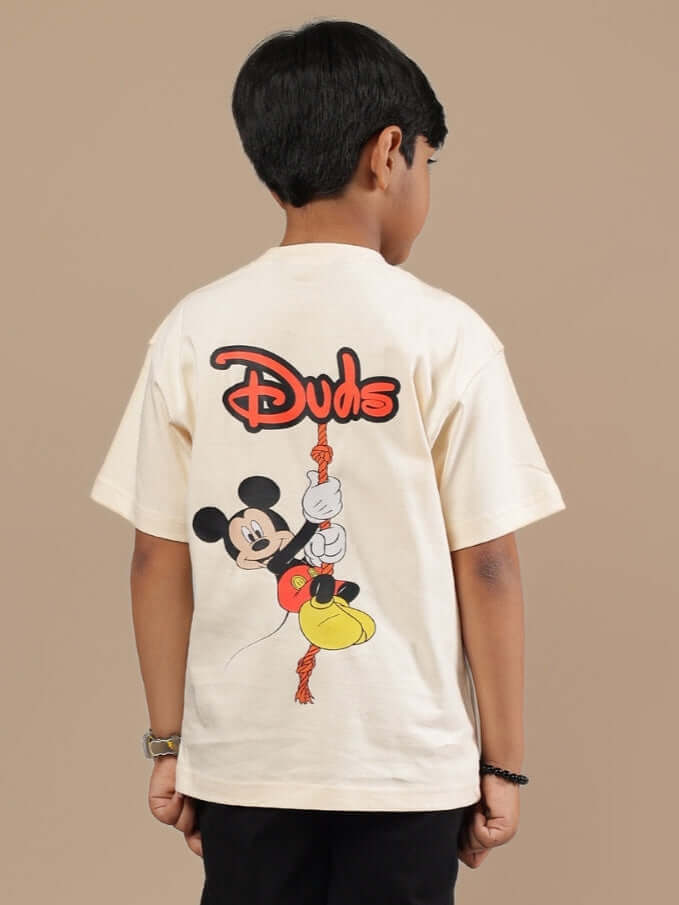 Boy wearing off-white DUDS Mouse T-shirt with cartoon character design on back, suitable for boys and girls.
