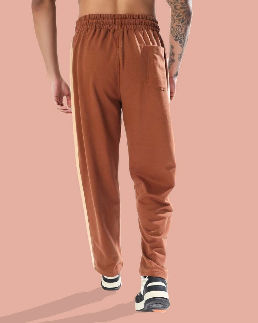 Back view of DUDS PLAY Baggy Joggers in brown-beige, showcasing elastic waistband and side stripe detail. Made to order by DUDS.