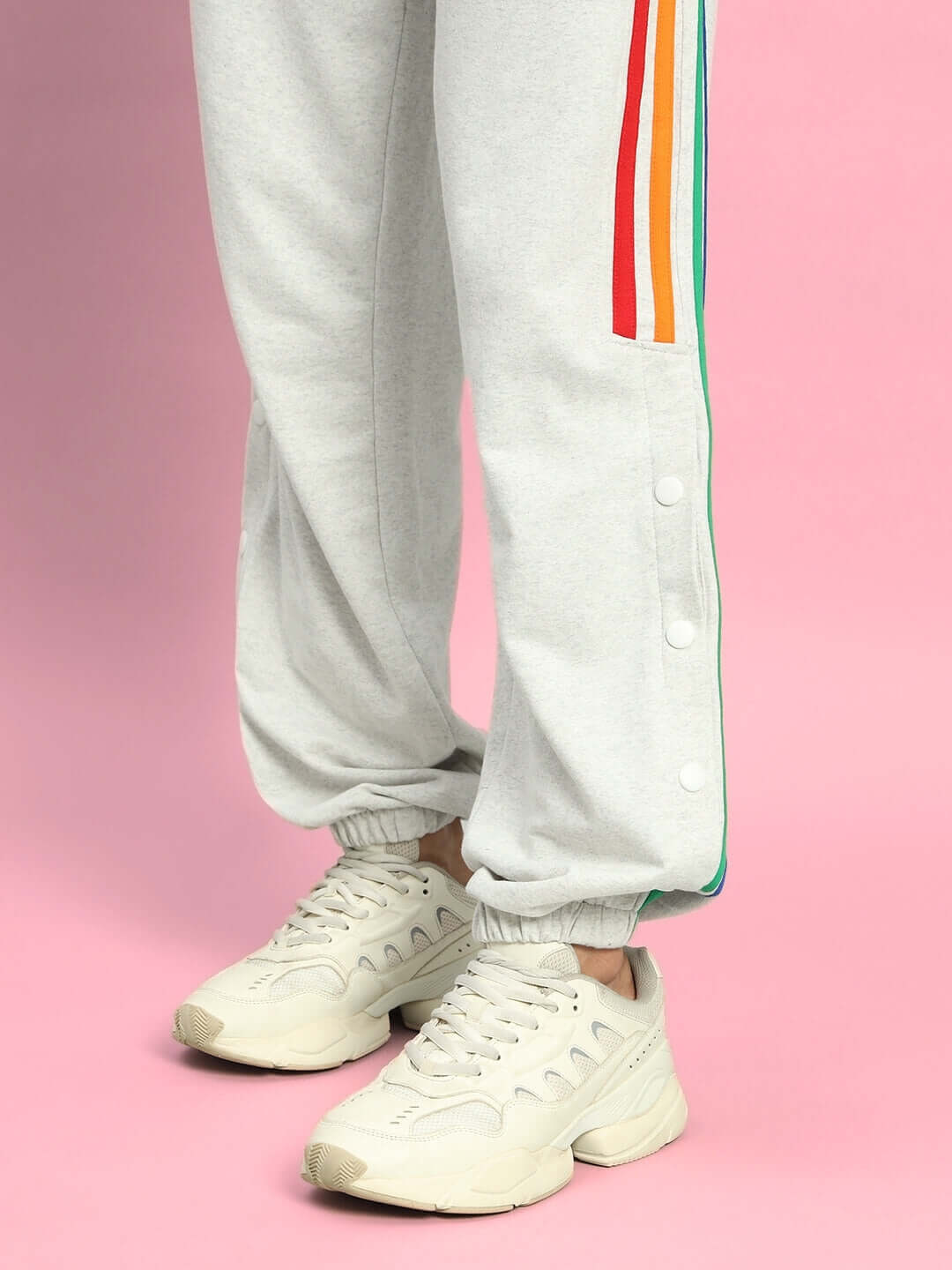 Person wearing DUDS Prism joggers in melange grey with colorful stripes, showcasing stylish comfort and a perfect fit.