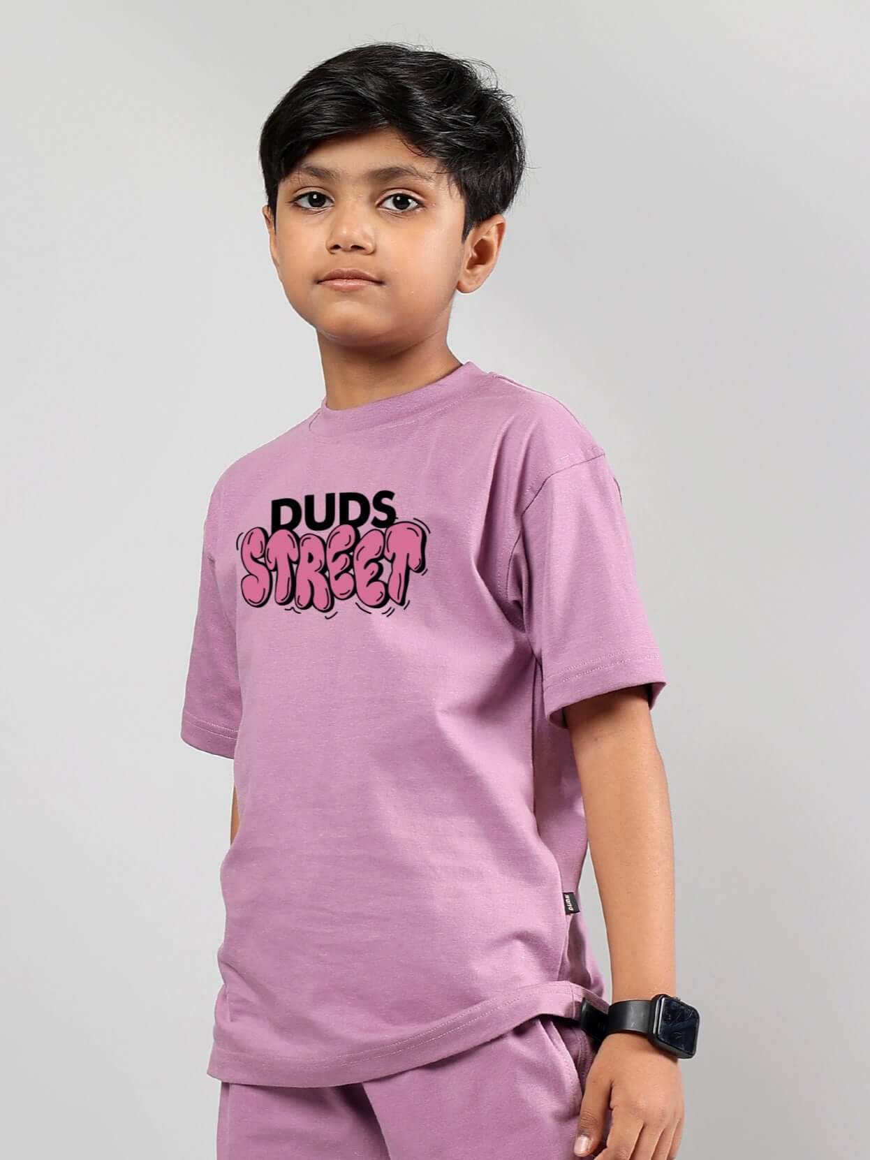 Boy wearing DUDS Street printed t-shirt in plum purple, showcasing casual style suitable for boys and girls.