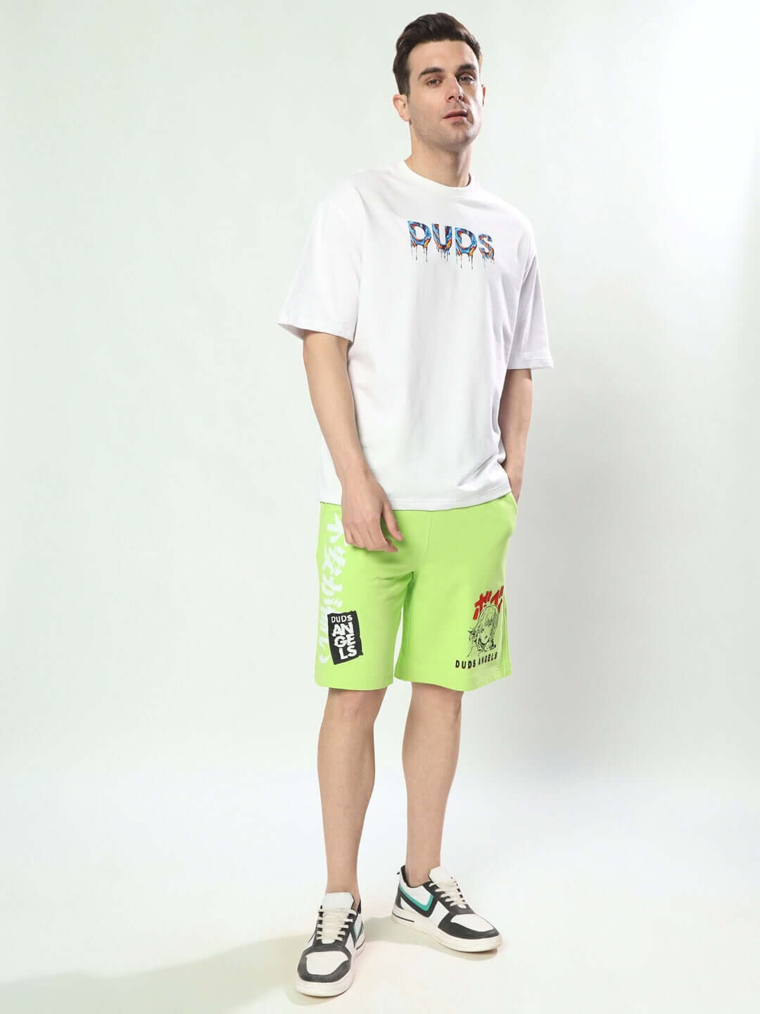 Man wearing DUDS anime girl neon green shorts with regular fit, paired with a white DUDS logo t-shirt.