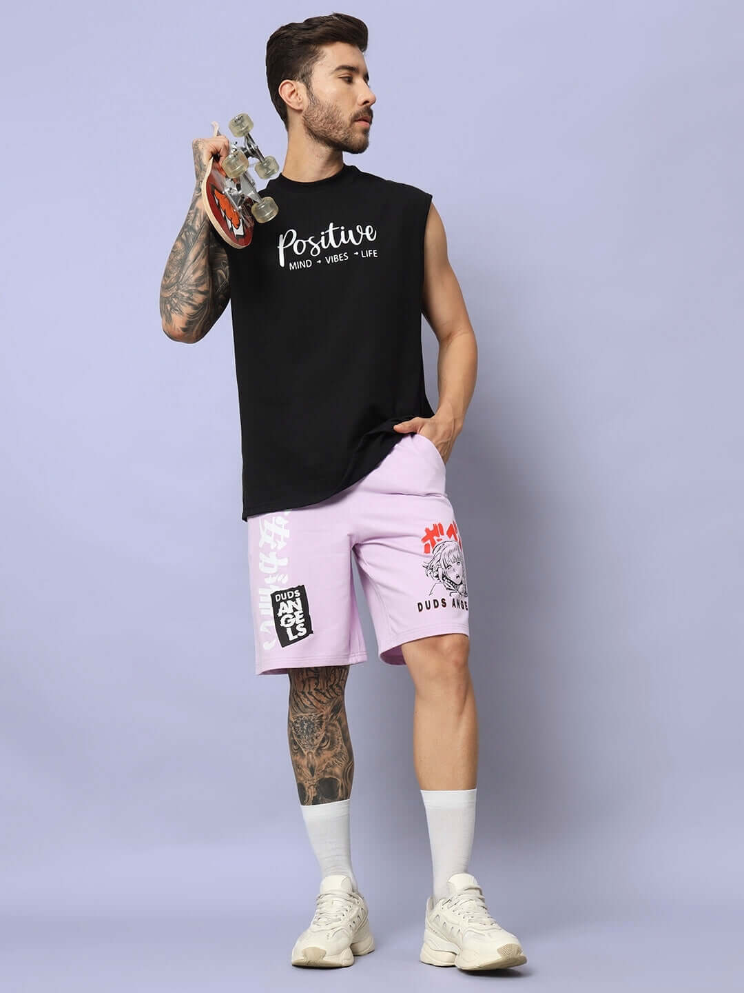 Man wearing DUDS Anime Girl lilac shorts with skateboard, showcasing regular fit style, perfect for casual outings.