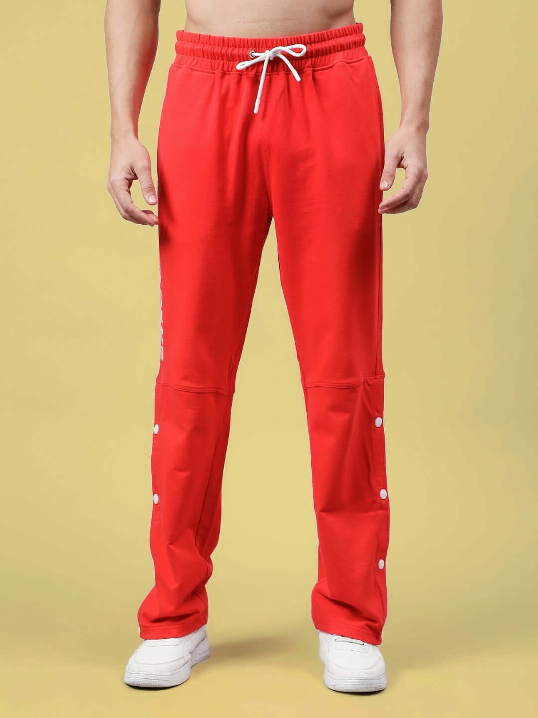 Person wearing red DUDS Racer Joggers with drawstring waist, showcasing comfortable and customizable fit, ideal for active wear.