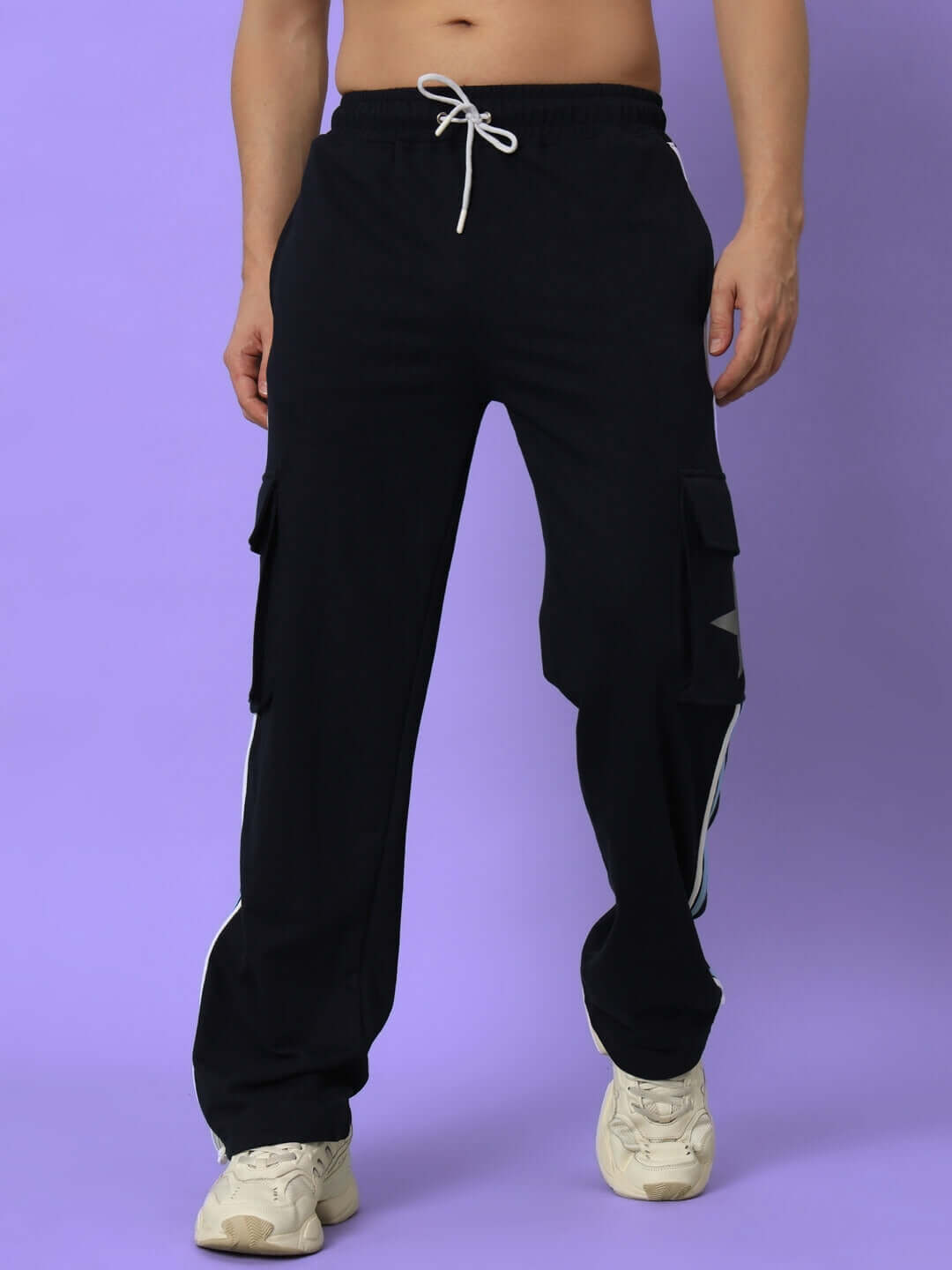 Man wearing navy blue DUDS FORCE JOGGERS with drawstring, against a purple background.