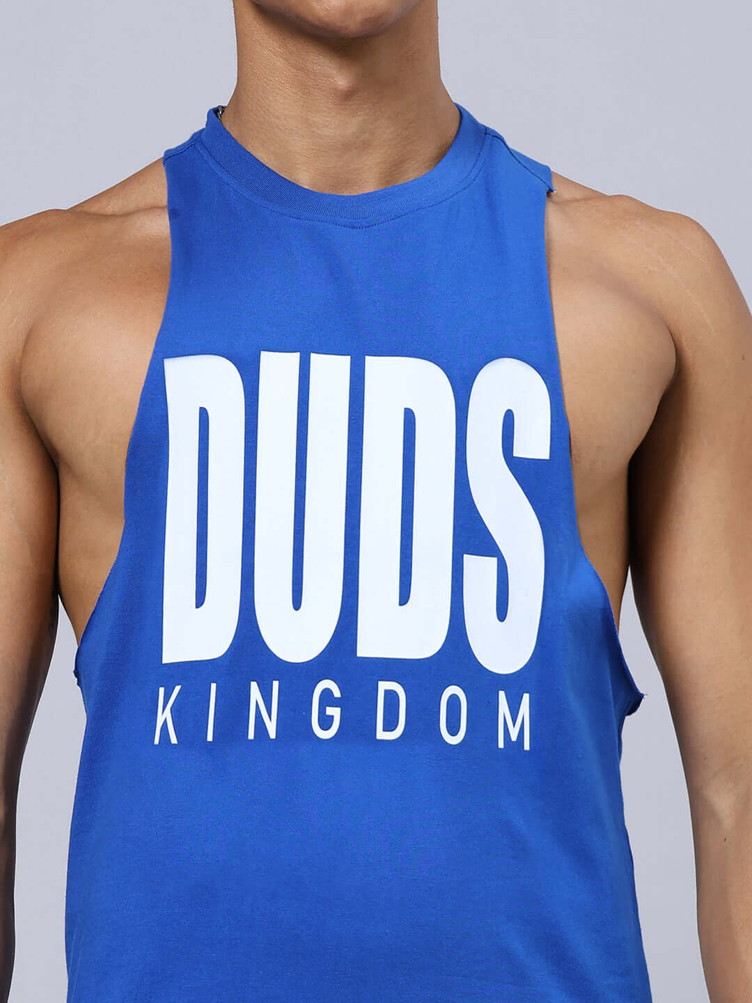 Close-up of blue DUDS KINGDOM GYM CO-ORD SET tank top, showcasing bold white lettering on a sleeveless shirt.
