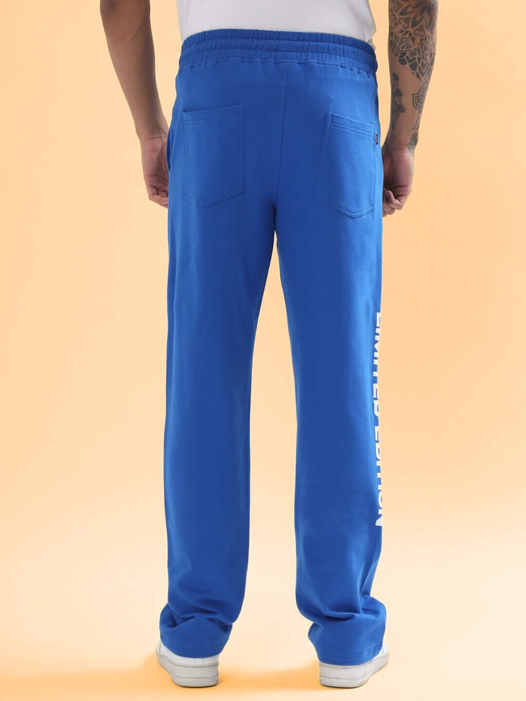 Person wearing DUDS Limited Edition Jogger in Royal Blue, showcasing back view with pockets and branding on leg. Made to order.