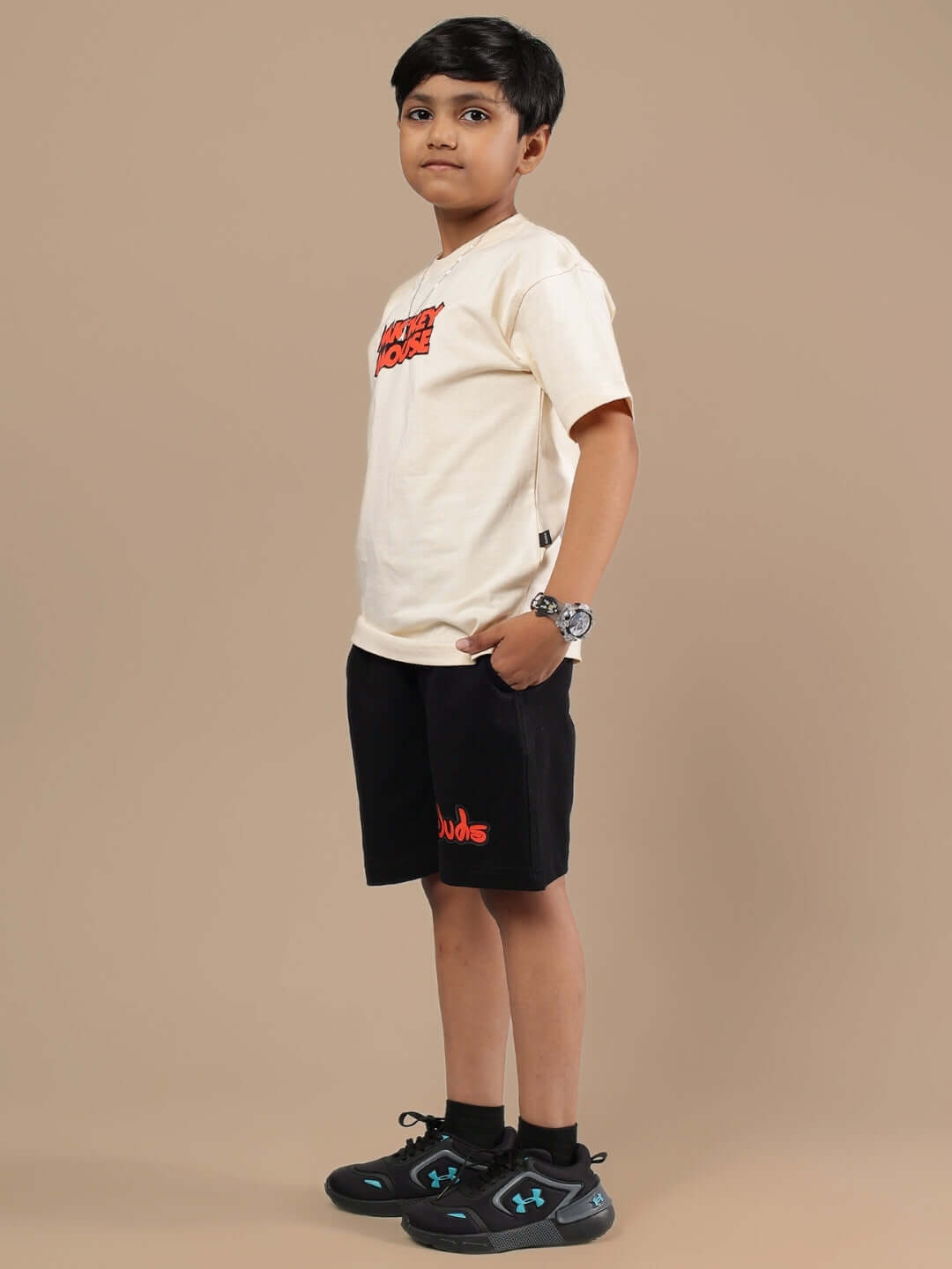 Alt Tag: Boy wearing DUDS MOUSE CO-ORD FOR BOYS & GIRLS BEIGE-BLACK outfit, beige t-shirt and black shorts, stylish children's fashion.