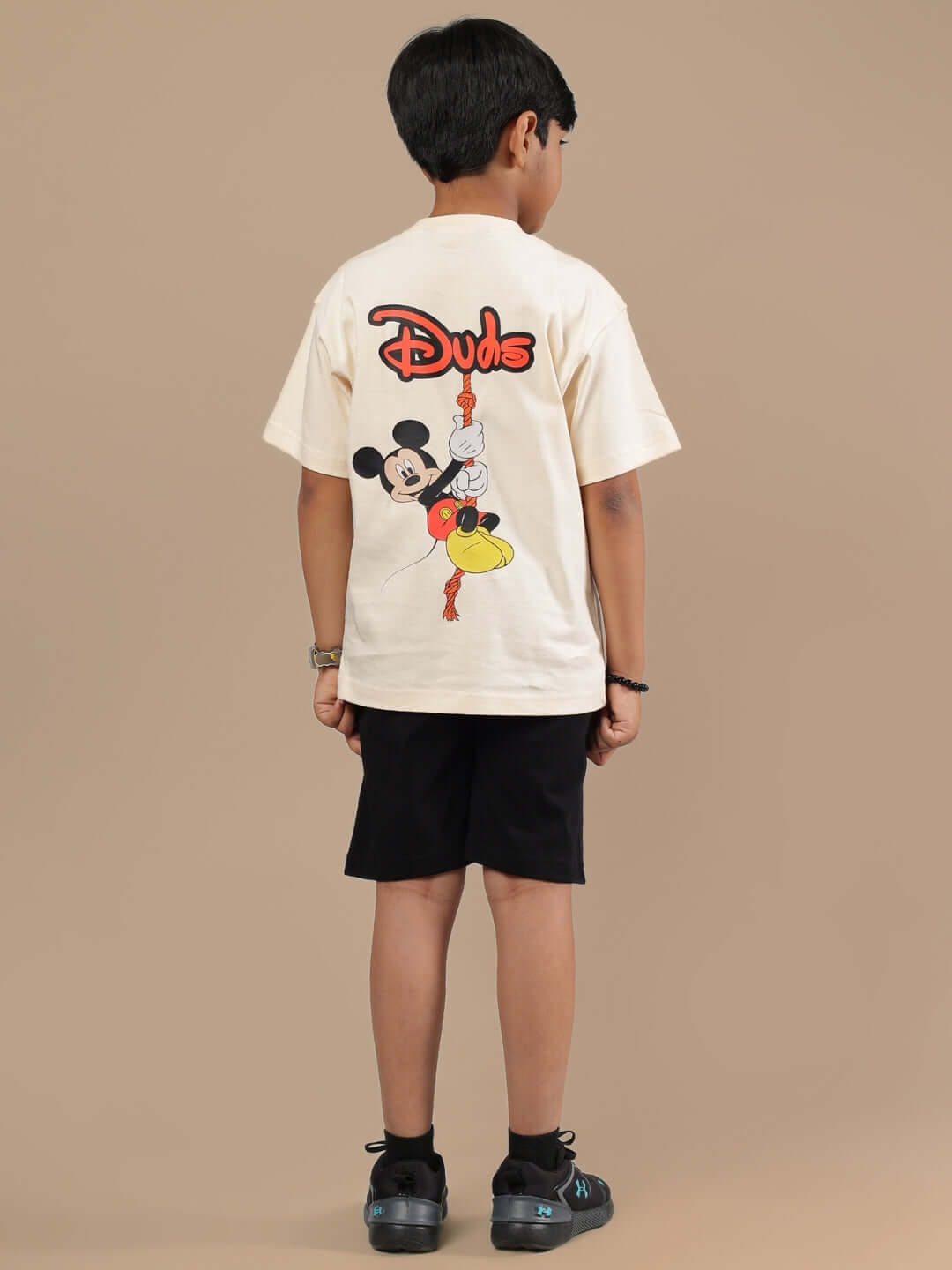 Child wearing beige and black DUDS Mouse Co-ord featuring cartoon design for boys and girls.