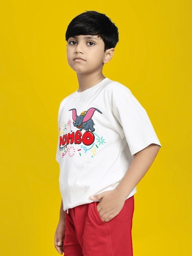 Child wearing DUMBO T-SHIRT FOR BOYS AND GIRLS WHITE standing against yellow background