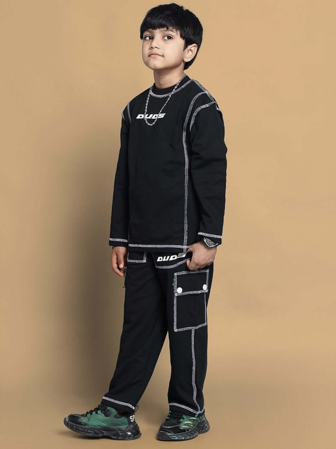 Boy wearing a dynamic oversized black co-ord set, featuring relaxed fit joggers and a long-sleeve top, suitable for boys and girls.
